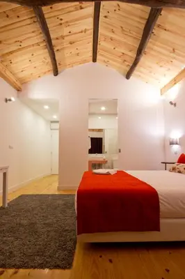 a bedroom with a large bed with red pillows at MyStay Porto Bolhão in Porto