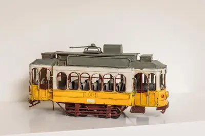 a model of a yellow train on a white background at BRA.com Apartments Oporto Bonfim in Porto