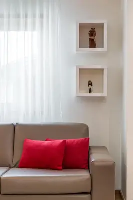 a couch with two red pillows in a living room at BRA.com Apartments Oporto Bonfim in Porto