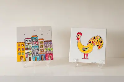 two paintings of a chicken and a painting of a city at BRA.com Apartments Oporto Bonfim in Porto