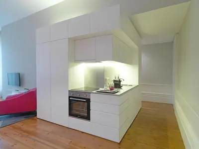 a kitchen with white cabinets and a stove at New Oporto Apartments - Mouzinho in Porto