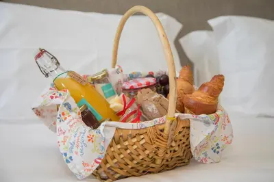 a basket of food and bread on a table at Liiiving in Porto | Art & Heart Studio in Porto