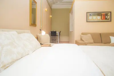 a bedroom with a white bed and a couch at Liiiving in Porto | Art & Heart Studio in Porto