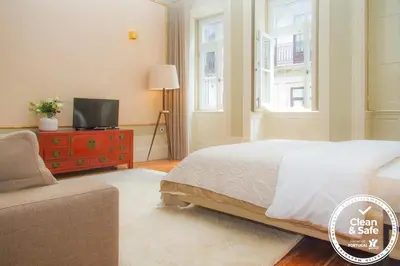 a bedroom with a bed and a tv on a dresser at Liiiving in Porto | Art & Heart Studio in Porto