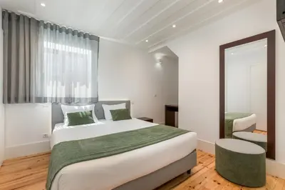 a bedroom with a large bed and a mirror at BRA.com Apartments Oporto Pinheiros in Porto