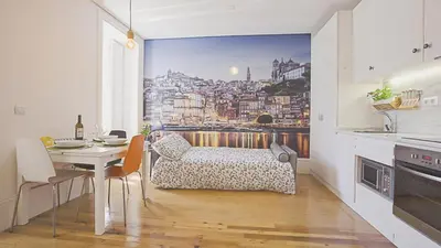 a kitchen with a dining table and a view of a city at BmyGuest - Almada Garden Apartment in Porto