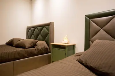 a bedroom with two beds and a nightstand with a bed sqor at GuestReady - Eiffel Waterfront apartments in Porto