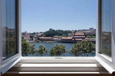 a bedroom with a large bed with blue pillows at Seventyset Flats - Porto Historical Center in Porto