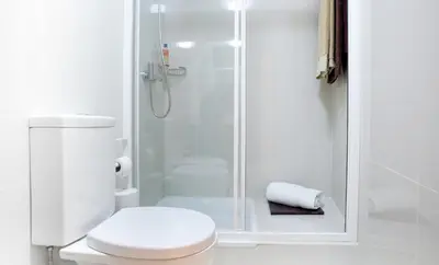 a white bathroom with a shower and a toilet at OPO Trinta e um in Porto