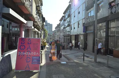 a couple walking down a street with a sign at Porto.arte downtown apartment in Porto