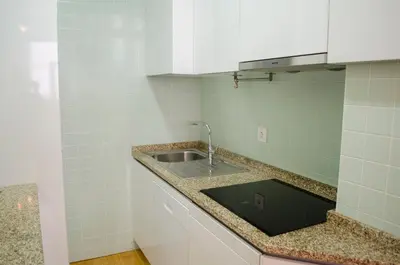 a kitchen counter with a sink and a mirror at Porto.arte downtown apartment in Porto