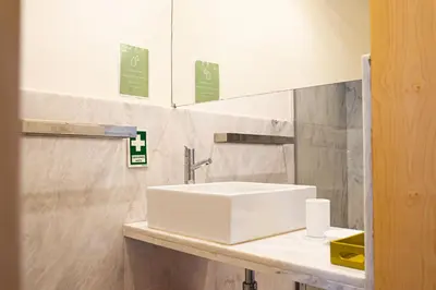 a bathroom with a white sink and a mirror at Impar Luxury Apartments in Porto