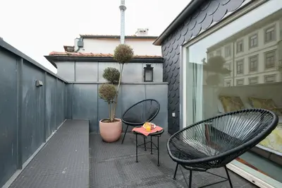 a small balcony with two chairs and a table at Impar Luxury Apartments in Porto
