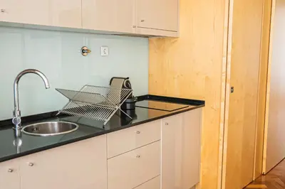 a kitchen with a sink and a counter top at Impar Luxury Apartments in Porto