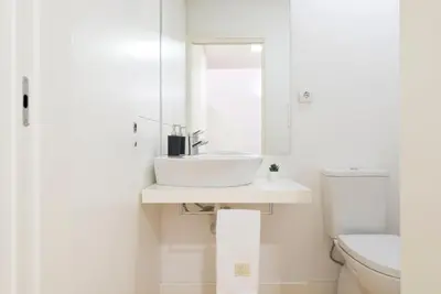 a white bathroom with a sink and a toilet at Apartment Firehouse by Sweet Porto - Free Parking in Porto