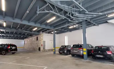 a parking lot with cars parked in a garage at Apartment Firehouse by Sweet Porto - Free Parking in Porto