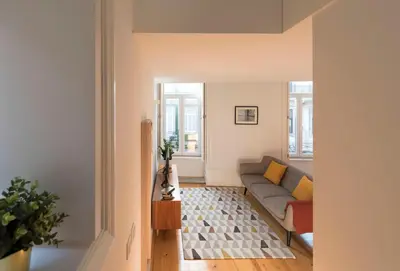 a living room with a couch and two windows at Apartment Firehouse by Sweet Porto - Free Parking in Porto