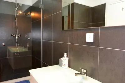 a bathroom with a shower and a sink and a mirror at Júlio Dinis Flat, by Flat in Porto in Porto