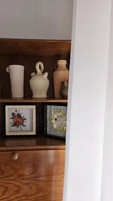 a wooden shelf with vases and pictures on it at Suite Porto in Porto