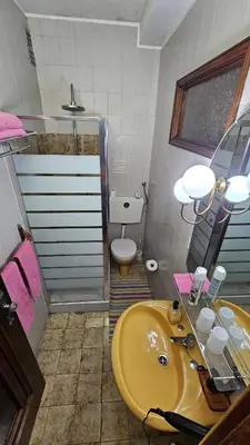 a bathroom with a yellow sink and a toilet at Suite Porto in Porto