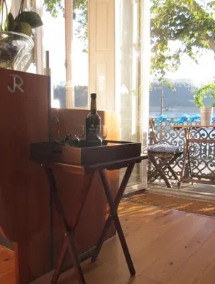 a table with a bottle of wine on top of it at Porto Douro River Guest House in Porto