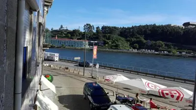 a view of a street with cars parked next to a river at Porto Douro River Guest House in Porto