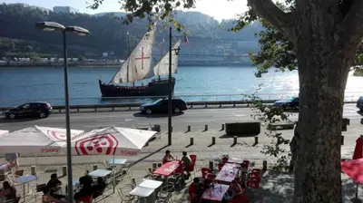 a boat in the water with people sitting at tables at Porto Douro River Guest House in Porto