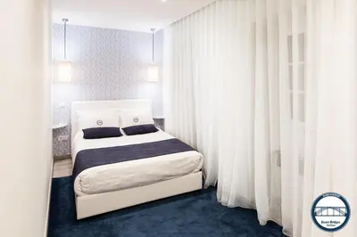 a bedroom with a bed with white curtains at Douro Riverside Apartments in Vila Nova de Gaia