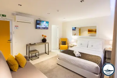 a hotel room with a bed and a couch at Douro Riverside Apartments in Vila Nova de Gaia
