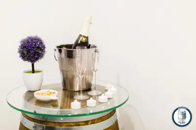 a glass table with a bottle of wine and candles at Douro Riverside Apartments in Vila Nova de Gaia