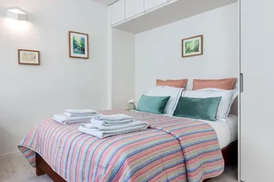 a bedroom with a bed with towels on it at Formosa Flats in Porto