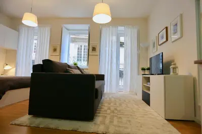 a living room with a couch and a television at D&S - Porto São Bento Apartments II in Porto