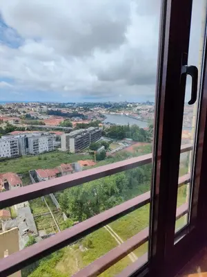 a view of a city from a window at Douro View Apartment in Vila Nova de Gaia