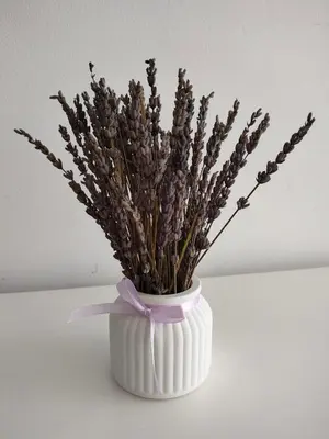 a white vase with a bunch of flowers in it at Douro View Apartment in Vila Nova de Gaia