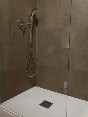 a shower with a shower head in a bathroom at Douro View Apartment in Vila Nova de Gaia