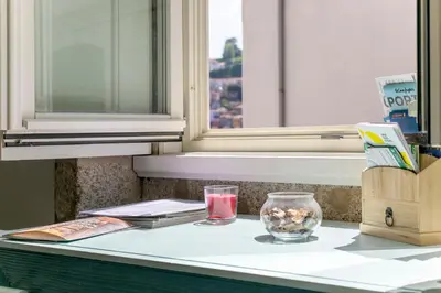 a counter with two glasses and a candle on it at Monchique´s Balcony in Porto