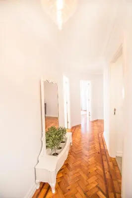 a white room with a mirror and a white bench at the5rooms.porto in Porto