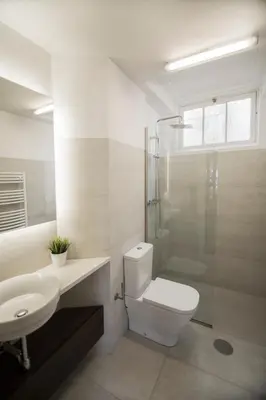 a bathroom with a toilet and a sink and a shower at the5rooms.porto in Porto