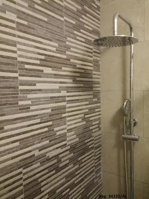 a bathroom with a shower with a stone wall at Douro & Sea - River Side in Vila Nova de Gaia