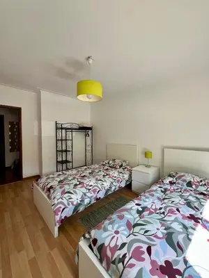 a bedroom with two beds and a yellow light at Douro & Sea - River Side in Vila Nova de Gaia