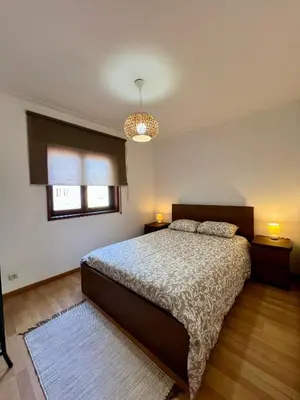 a bedroom with a bed and two lamps and a window at Douro & Sea - River Side in Vila Nova de Gaia