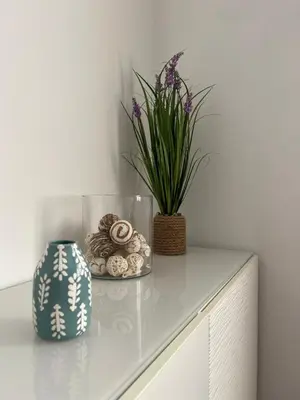 a table with a vase and a plant on it at Douro & Sea - River Side in Vila Nova de Gaia