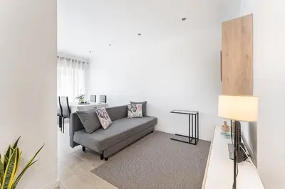 a living room with a couch and a table at Casa Trindade in Porto