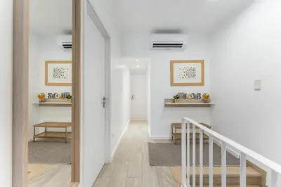 a hallway with white walls and a white stairway at Casa Trindade in Porto