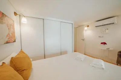 a bedroom with a white bed with glass walls at Historic & Sunny Mezzanine Bolhão by Vacationy in Porto