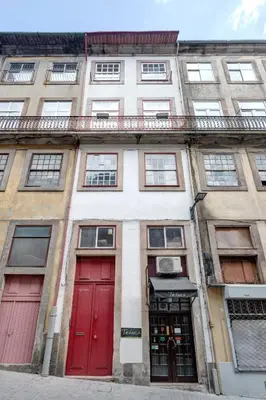 an apartment building with red doors and windows at Own Places Clérigos Apartments in Porto