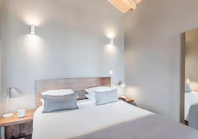 a bedroom with a large white bed with two pillows at Oporto Street Sá de Noronha in Porto