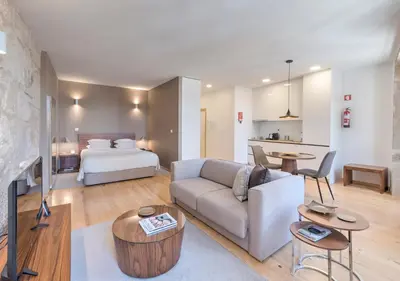 a living room with a couch and a bed at Oporto Street Sá de Noronha in Porto