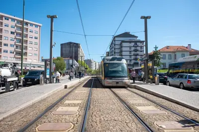 a train is on the tracks in a city at Avenida Apartment by MP in Vila Nova de Gaia