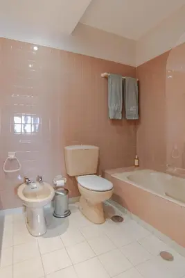 a bathroom with a toilet and a tub and a sink at Avenida Apartment by MP in Vila Nova de Gaia